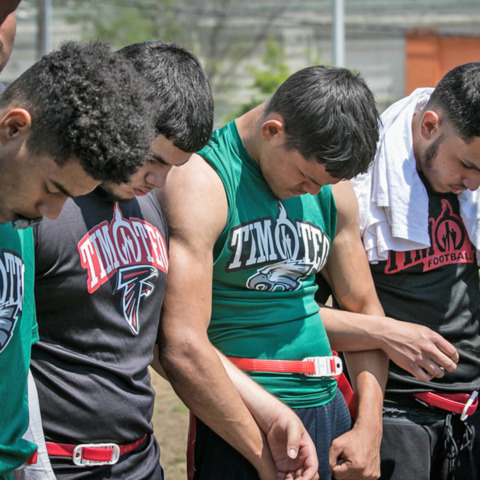 Smiling Mother Playing With Baby Son At Home